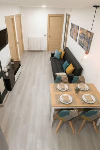 a living room with a couch and a table at CHECK-IN 24H NUEVO Único WIFI FAMILIAR Centro Planta 3 in Zaragoza