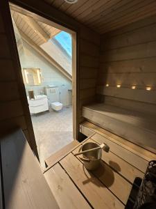 a sauna with a bowl on a wooden table at Naava Chalet Penthouse - Kattohuoneisto järvinäköalalla in Ähtäri +34 photos