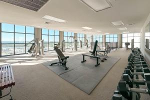 a gym with treadmills and chairs in a building at The Oasis 2210 in Romar Beach