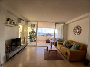 a living room with a couch and a table at El nido del mar in Almería