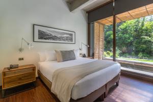 a bedroom with a large bed and a large window at The Place in Santiago