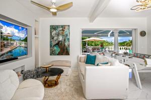 a living room with a pool table and a couch at Villa Princess sea view private pool Anse Marcel in Saint Martin