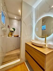a bathroom with a sink and a mirror at Villa Princess sea view private pool Anse Marcel in Saint Martin