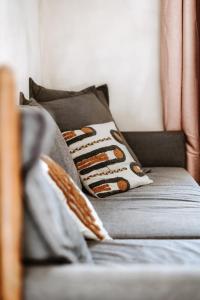 een bank met kussens erop in een woonkamer bij Gîte de la maraîchère in Ittre