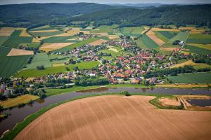 an aerial view of a village in the hills at FeWo Blickweite in Hessisch Oldendorf