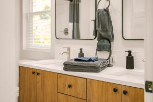 a bathroom with a sink and a mirror at Bright & Cozy 4BR Retreat Near Downtown Gresham in Gresham +32 photos