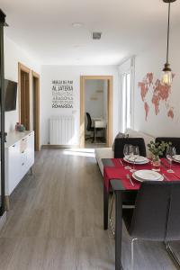 ein Wohnzimmer mit einem Tisch und ein Zimmer mit einer Küche in der Unterkunft EXCLUSIVO TAPAS EL TUBO CHECKIN 24H Centro 1 in Saragossa