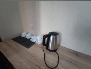 a tea kettle sitting on top of a wooden floor at Hotel Naqsh-band Terrace in Bukhara