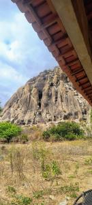 a large rocky mountain in the middle of a field at Abrigo Quixadá in Quixadá +5 photos