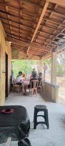a group of people sitting at a table on a patio at Abrigo Quixadá in Quixadá