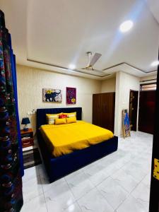 a bedroom with a bed with a yellow blanket at Modern 2-Bedroom Apt with African Vibe- Cape Coast in Cape Coast