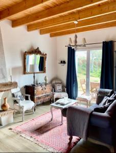 a living room with a couch and a table at " Goarem Bihan" Villa de Charme Front de Mer in Plouarzel
