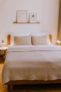 a bedroom with a large bed with a striped comforter at JUGA Apartmány in Jaroslavice
