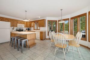 a kitchen and dining room with a table and chairs at Beavershore-Direct Access to Beaver Lake-Sleeps 12 in Pine Top