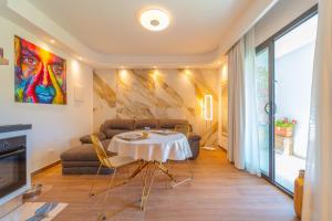 a living room with a table and a couch at Dream house in Olbia