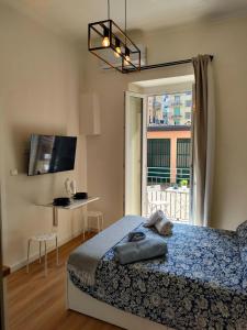 a bedroom with a bed and a large window at Noblerot in Turin