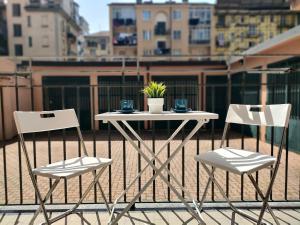 a white table and two chairs on a balcony at Noblerot in Turin