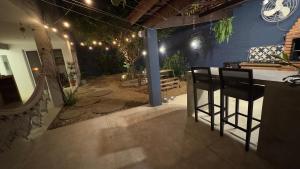 a patio with a bar with chairs and a table at Charmosa hospedagem no Jardim Secreto SP in Sao Paulo +21 photos