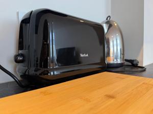 a black toaster oven sitting on top of a counter at Spacious and Design Loft in Brussels