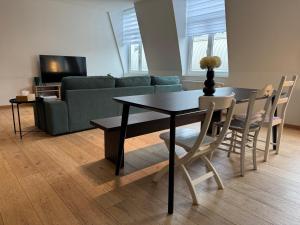a living room with a table and a couch at Spacious and Design Loft in Brussels +8 photos