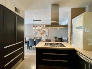 a kitchen with a stove and a dining room at Casa Sendero in Senecú +28 photos