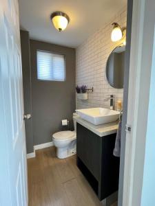 a bathroom with a sink and a toilet and a mirror at Casa Sendero in Senecú