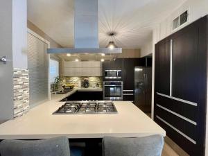 a kitchen with a stove and a counter top at Casa Sendero in Senecú