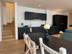 a kitchen and living room with a table and chairs at Spacious and Design Loft in Brussels