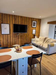 a living room with a couch and a table at A Cybiclette in Saint-Étienne-lès-Remiremont