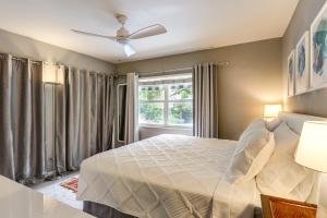 a bedroom with a bed and a window at 1 Mi to Lake Worth Beach Park Poolside Paradise! in Lake Worth +18 photos