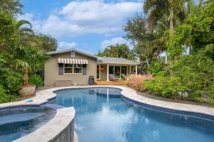 a swimming pool in front of a house at 1 Mi to Lake Worth Beach Park Poolside Paradise! in Lake Worth