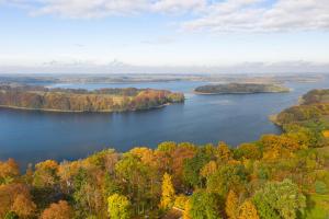 an aerial view of a lake in the fall at Domy całoroczne Cieszyno in Cieszyno