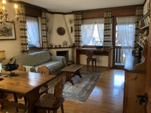 a living room with a couch and a table at Appartamento Croda with Large Panoramic Terrace and Private Garage in Cortina dʼAmpezzo