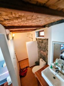 a bathroom with a sink and a toilet at Casa Praia Tarrafal de Monte Trigo in Seladinha