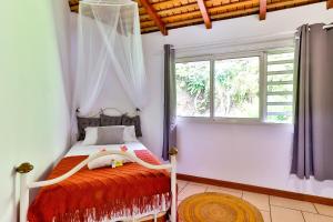a bedroom with a bed and a window at Blue Horizon - La Villa Sora - Pool - Sea view in Punaauia +45 photos