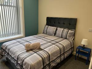 a bedroom with a bed with a pillow on it at Apollo Apartment at Edgerton Suites in Huddersfield