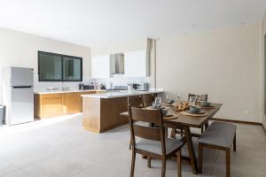 a kitchen with a table and chairs and a television at Casa Florencia Ensenada Home 3BR WIFi & BBQ 10 Guests in Ensenada +35 photos