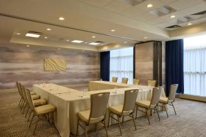 a conference room with a long table and chairs at Detroit Marriott Troy in Troy +32 photos