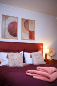 a bedroom with a bed with two towels on it at House with garden 30 minutes to Disneyland and center of Paris in Montreuil