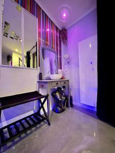 a room with a mirror and a table with a sink at LoveroomL1TIMISTE TAR in La Rochelle
