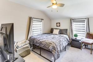 a bedroom with a bed and a flat screen tv at Cozy Home 4 Mi to YSU Campus Penguins Welcome! in Boardman