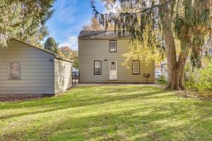 a house with a tree in front of a yard at Cozy Home 4 Mi to YSU Campus Penguins Welcome! in Boardman