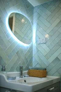 a bathroom with a sink and a mirror at House with garden 30 minutes to Disneyland and center of Paris in Montreuil +25 photos