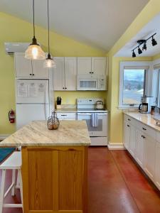 a kitchen with white cabinets and a counter top at Fantastic Vacation Rental on an Authentic Farm in Hartland, Vermont in Sheddsville +12 photos