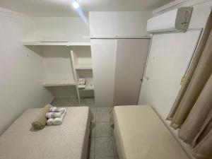 a small room with two beds and a refrigerator at COP 30 - Imóvel Próximo ao Aeroporto e ao Hangar - 02 in Belém +9 photos