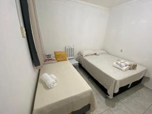 a small room with two beds and a tv at COP 30 - Imóvel Próximo ao Aeroporto e ao Hangar - 02 in Belém