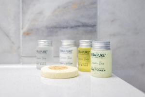 a group of four bottles of paint on a counter at Dog Friendly - 8min to Downtown - FAST Wifi in St Petersburg +8 photos