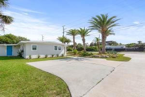 a house with palm trees and a driveway at Duplex-Both Units Bungalow A&B Matanzas Launch in St. Augustine