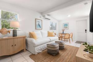 a living room with a white couch and a table at Duplex-Both Units Bungalow A&B Matanzas Launch in St. Augustine