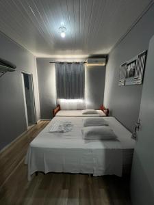 a bedroom with a large white bed in a room at Hotel Imperial in Toledo